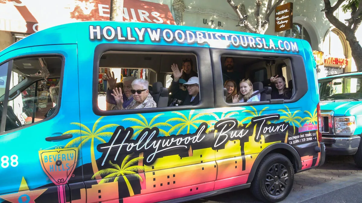 Tourists enjoying a Hollywood bus tour, seated inside the bus