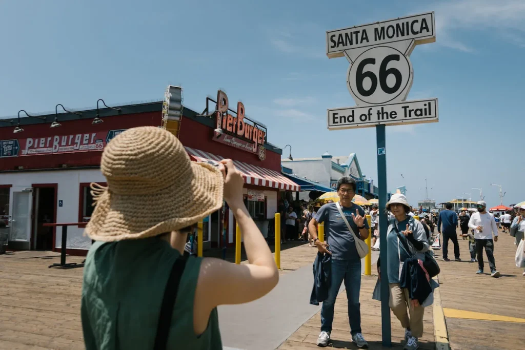 Tourists In Front Of Santa Monica Sign