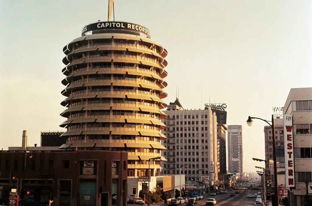 Capitol Records Building in the 1980s with vintage cars and classic Hollywood street scene.
