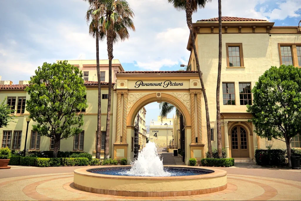 Front entrance of Paramount Pictures Studios with iconic archway and gate on Melrose Avenue.