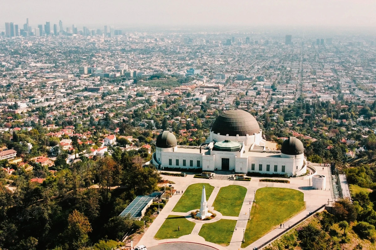 Aerial view of Griffith Observatory with sprawling Los Angeles cityscape in the background.