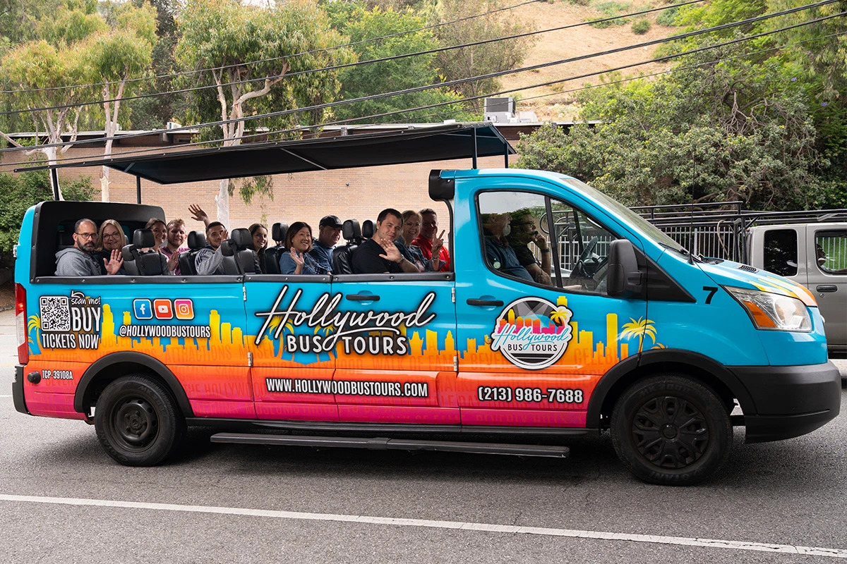 Hollywood sightseeing bus tour with tourists exploring LA attractions