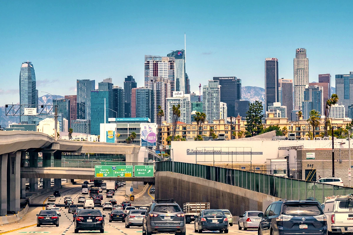 Downtown LA skyline from freeway with traffic and urban landscape