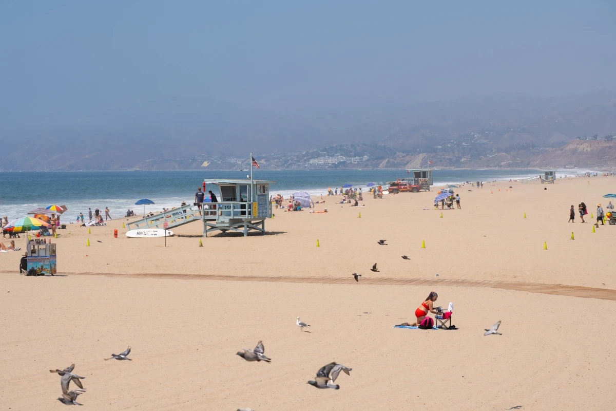 Santa Monica Beach lifeguard tower with beachgoers and Pacific Ocean view