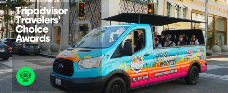 Trip Advisor logo on a photo of a bright blue and orange open-air Hollywood Bus Tours vehicle filled with smiling passengers waves at the camera while driving along a tree-lined street.