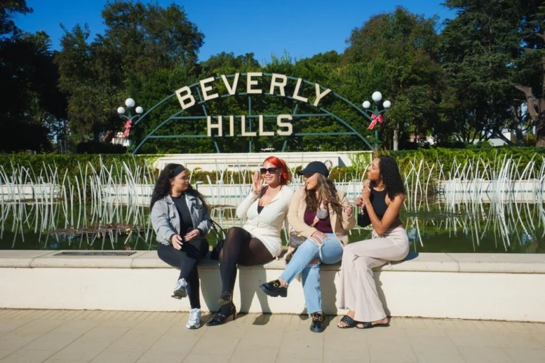 Private Beverly Hills tour group sitting near Beverly Hills sign