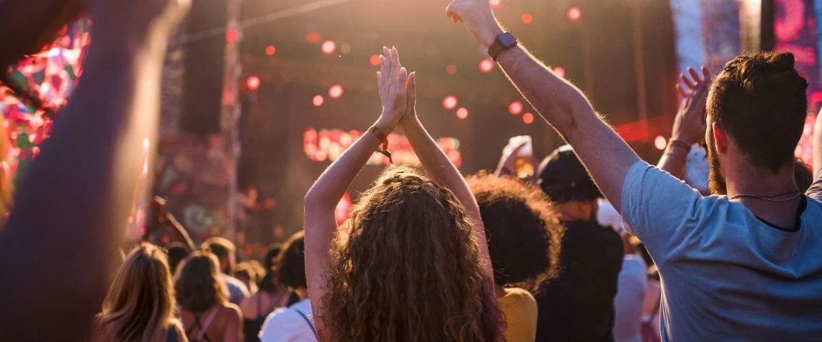 Crowd of people with raised hands enjoying a live music festival concert in Los Angeles in 2026