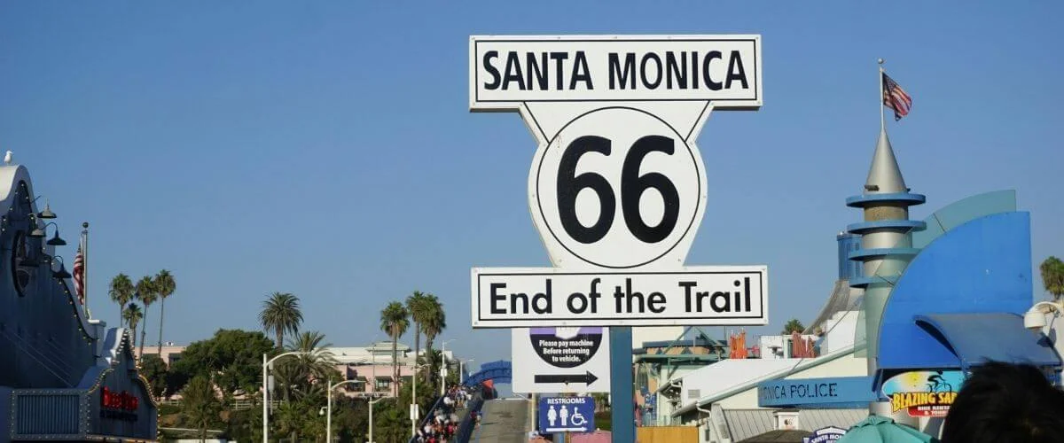 Historic Route 66 End of the Trail sign at Santa Monica Pier marking the western end of Route 66 in California.