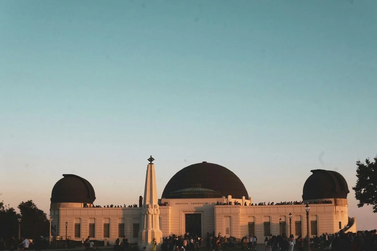 Griffith Observatory dome at sunset with crowd of visitors
