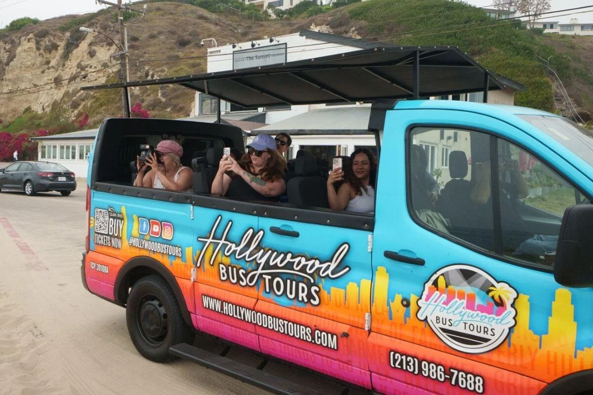 Open air Hollywood Bus Tours van with passengers sightseeing