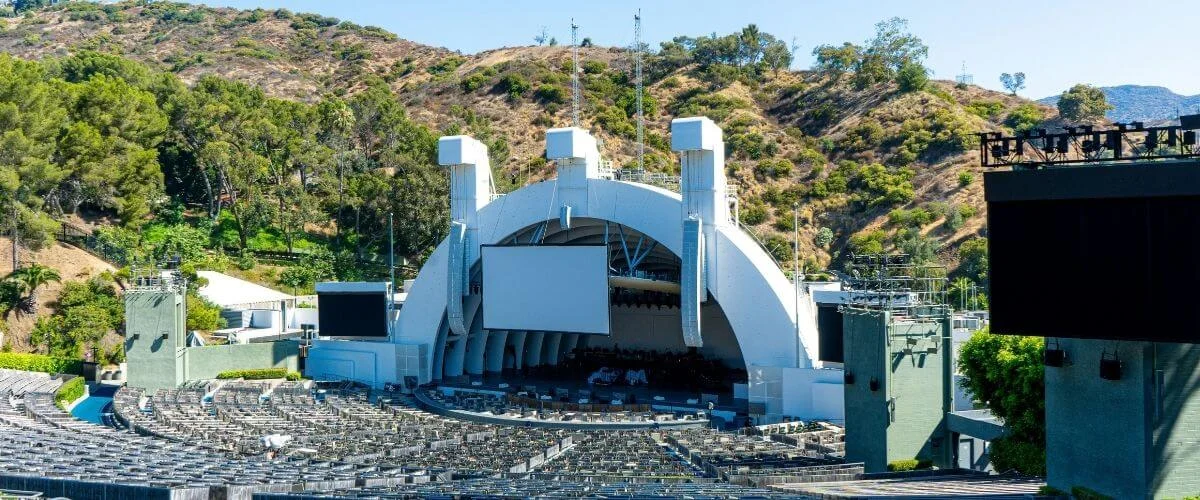 Wide view of the Hollywood Bowl stage shell nestled against a dry chaparral hillside