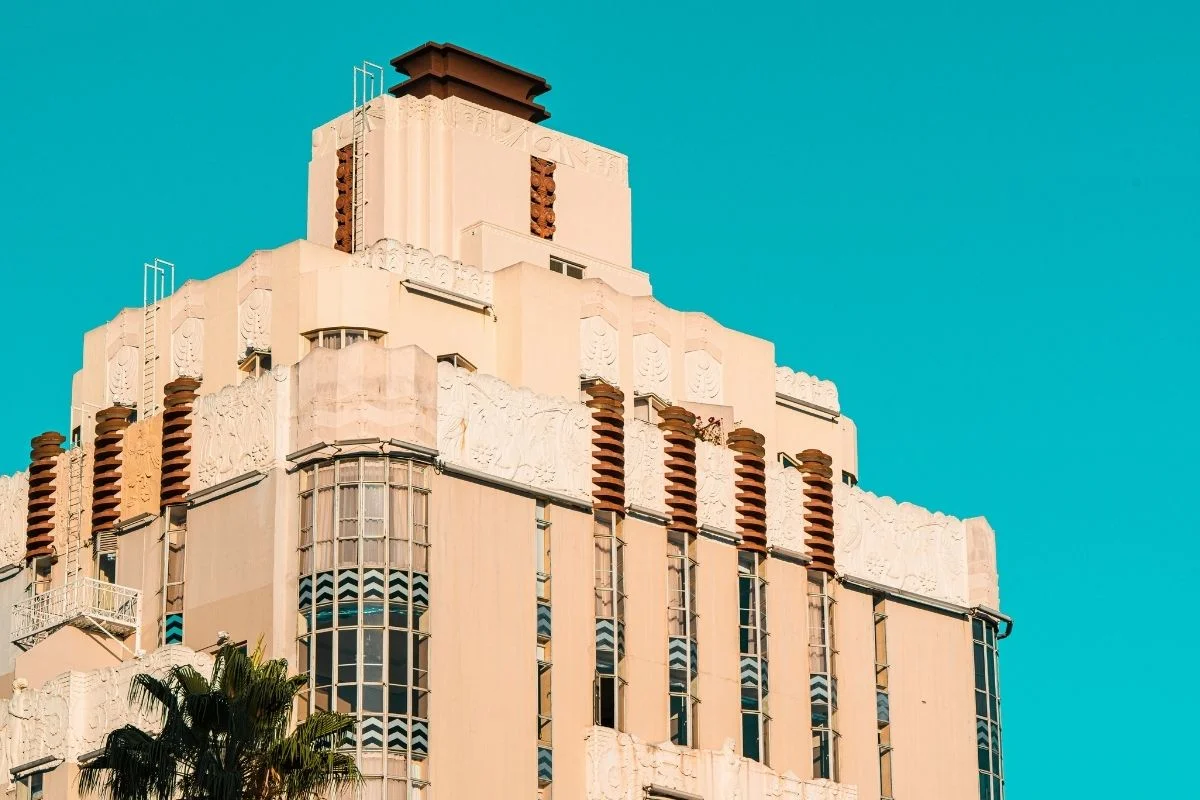 Art Deco building facade against teal sky in West Hollywood