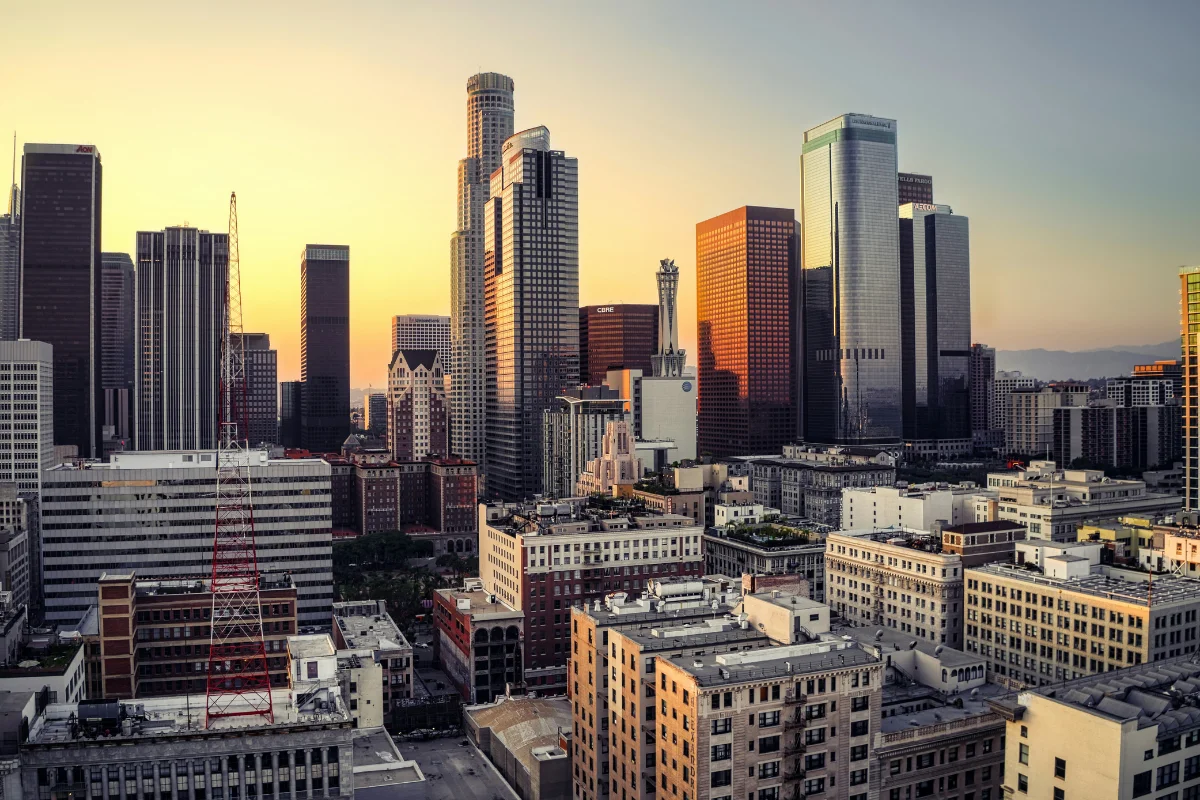 Downtown Los Angeles skyline with sun reflecting off skyscrapers during golden hour