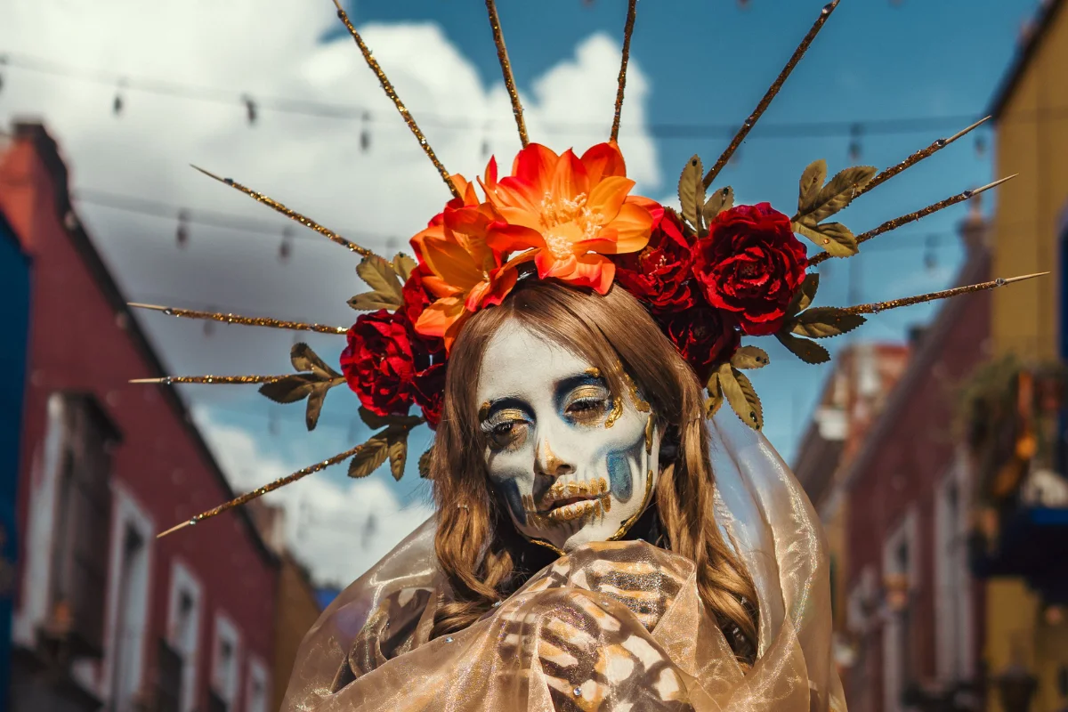 Woman in Day of the Dead makeup and flower headdress at Halloween event
