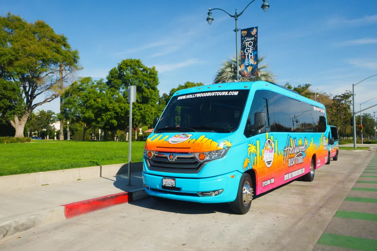 Blue Hollywood Bus Tours branded sightseeing bus parked on a sunny Los Angeles street