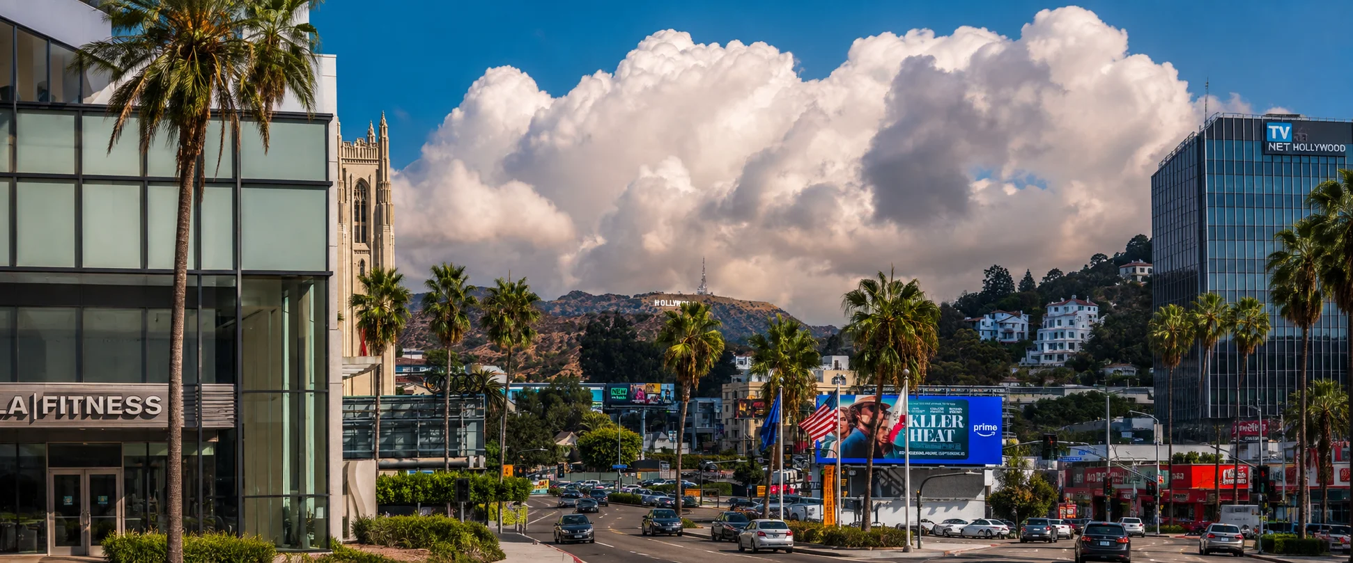Sunset Blvd in West Hollywood with palm trees and Hollywood sign in background